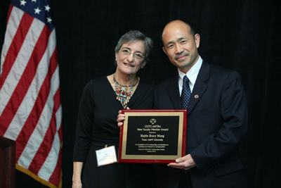 Photo of Bruce Wang receiving New Faculty Award